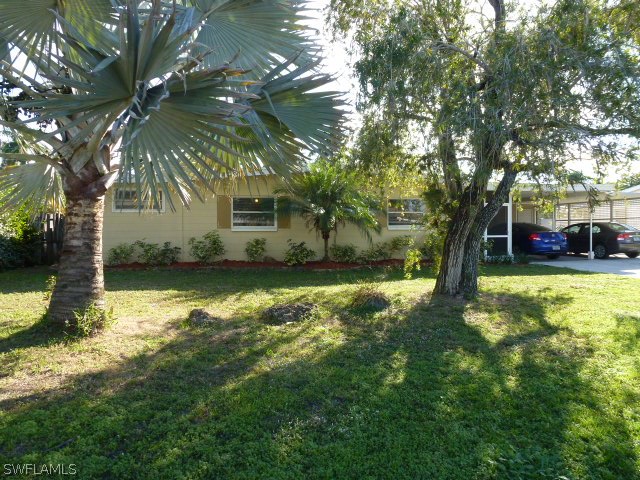 1450 Mandel Road Fort Myers, FL 33919 - Photo 1 of 18 a view of a house with a yard
