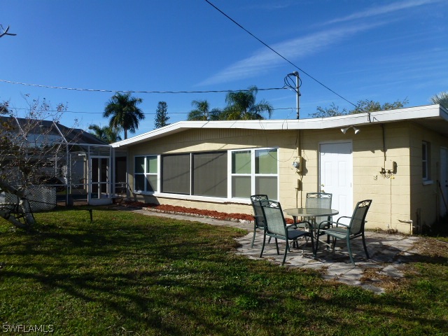 1450 Mandel Road Fort Myers, FL 33919 - Photo 3 of 18 a view of a house with backyard sitting area and garden