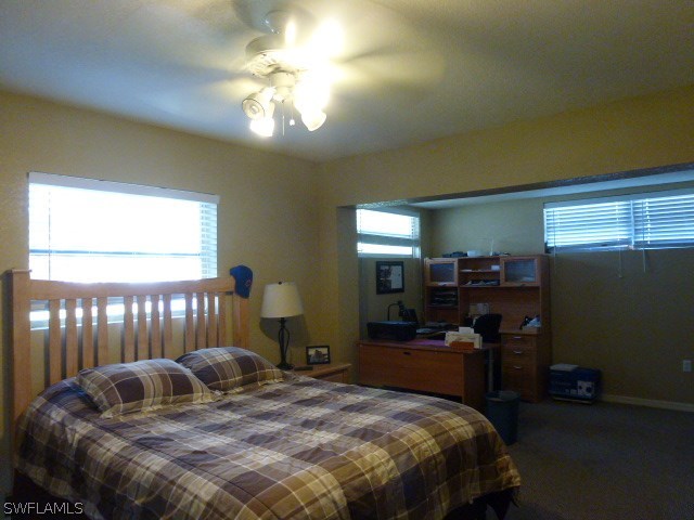 1450 Mandel Road Fort Myers, FL 33919 - Photo 4 of 18 a bedroom with a bed and a chandelier