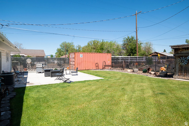 340 West 100 N Street Beaver, UT 84713 - Photo 33 of 37 Expansive backyard featuring a large concrete patio, a manicured lawn, and perimeter fencing
