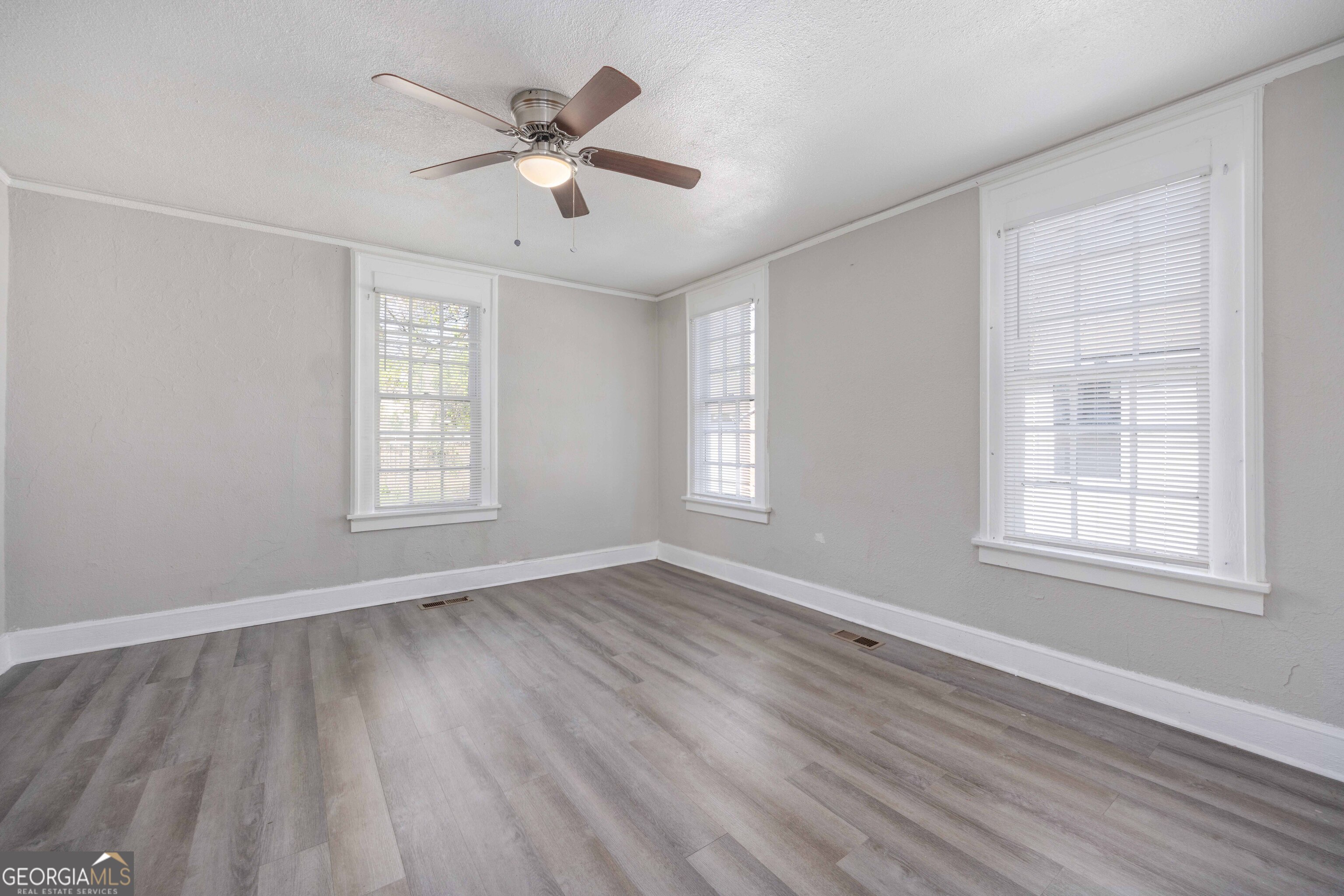 1103 Bryan Avenue Columbus, GA 31906 - Photo 11 of 24 a view of an empty room with wooden floor and a window