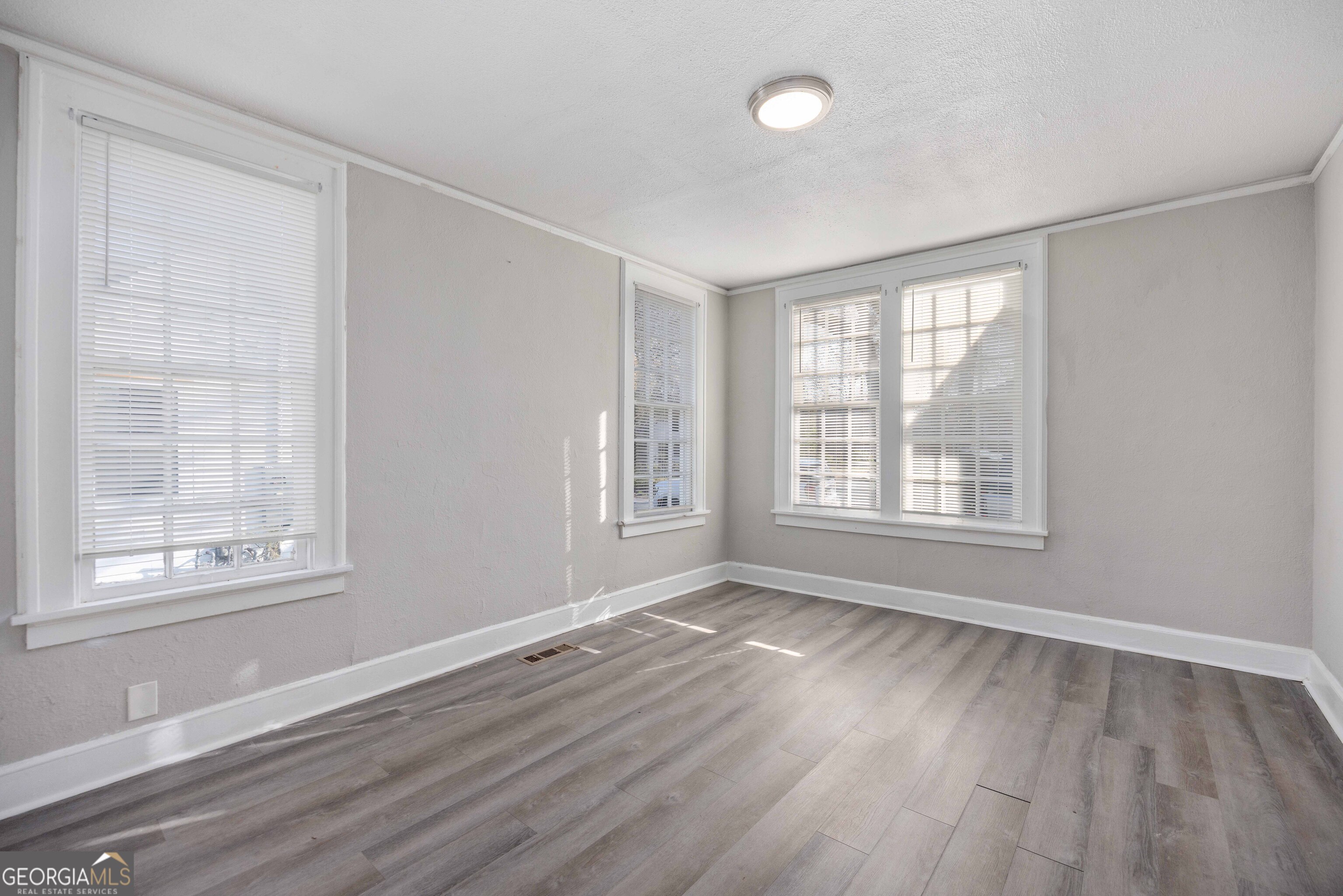1103 Bryan Avenue Columbus, GA 31906 - Photo 13 of 24 a view of an empty room with wooden floor and a window