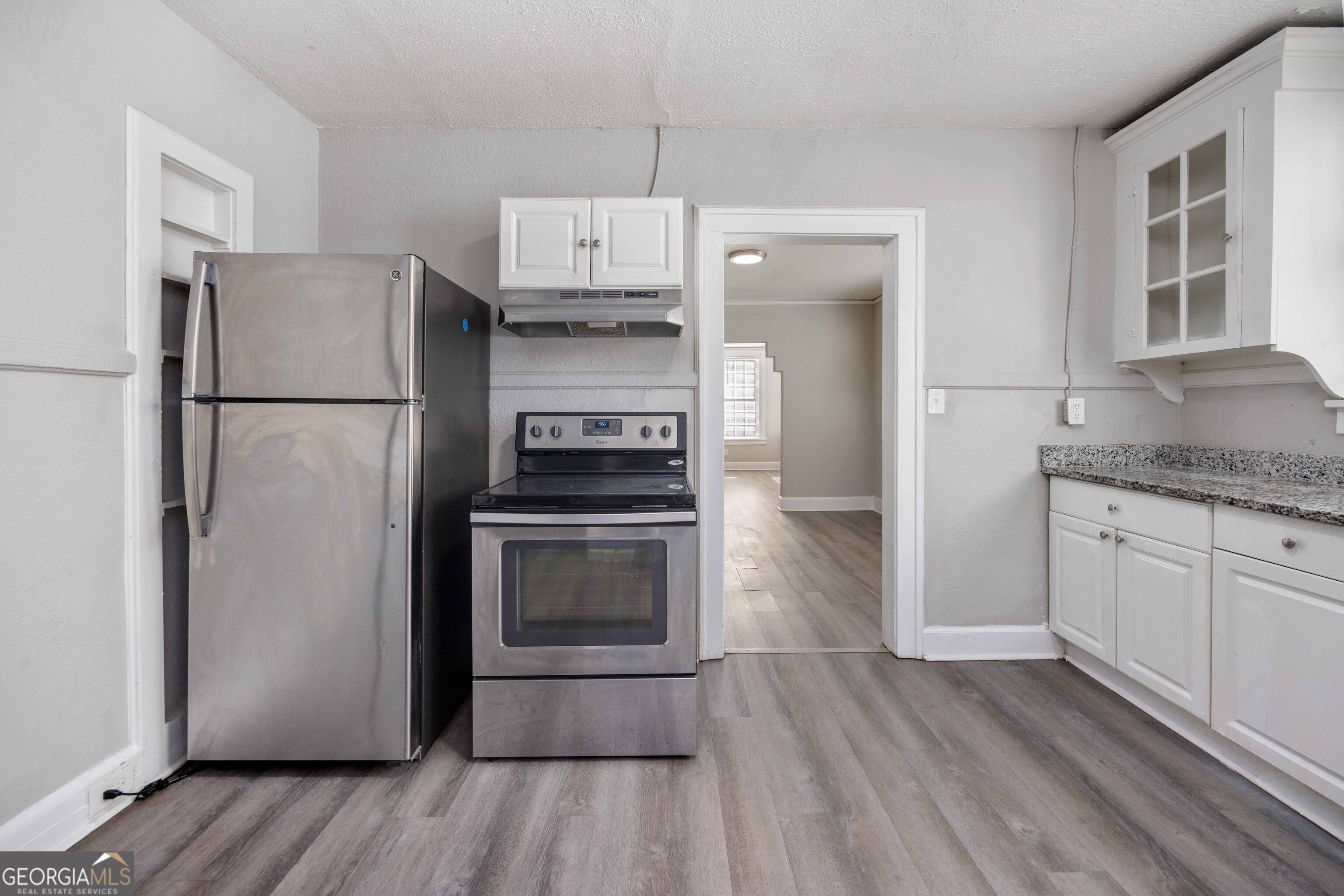 1103 Bryan Avenue Columbus, GA 31906 - Photo 2 of 24 a kitchen with a refrigerator and a stove top oven