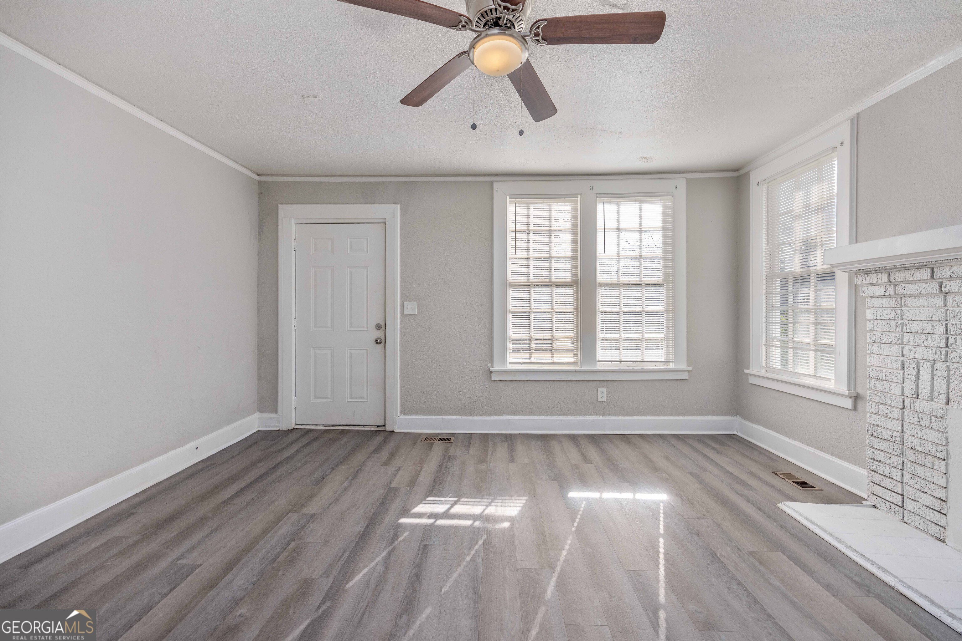 1103 Bryan Avenue Columbus, GA 31906 - Photo 5 of 24 a view of empty room with wooden floor and fan