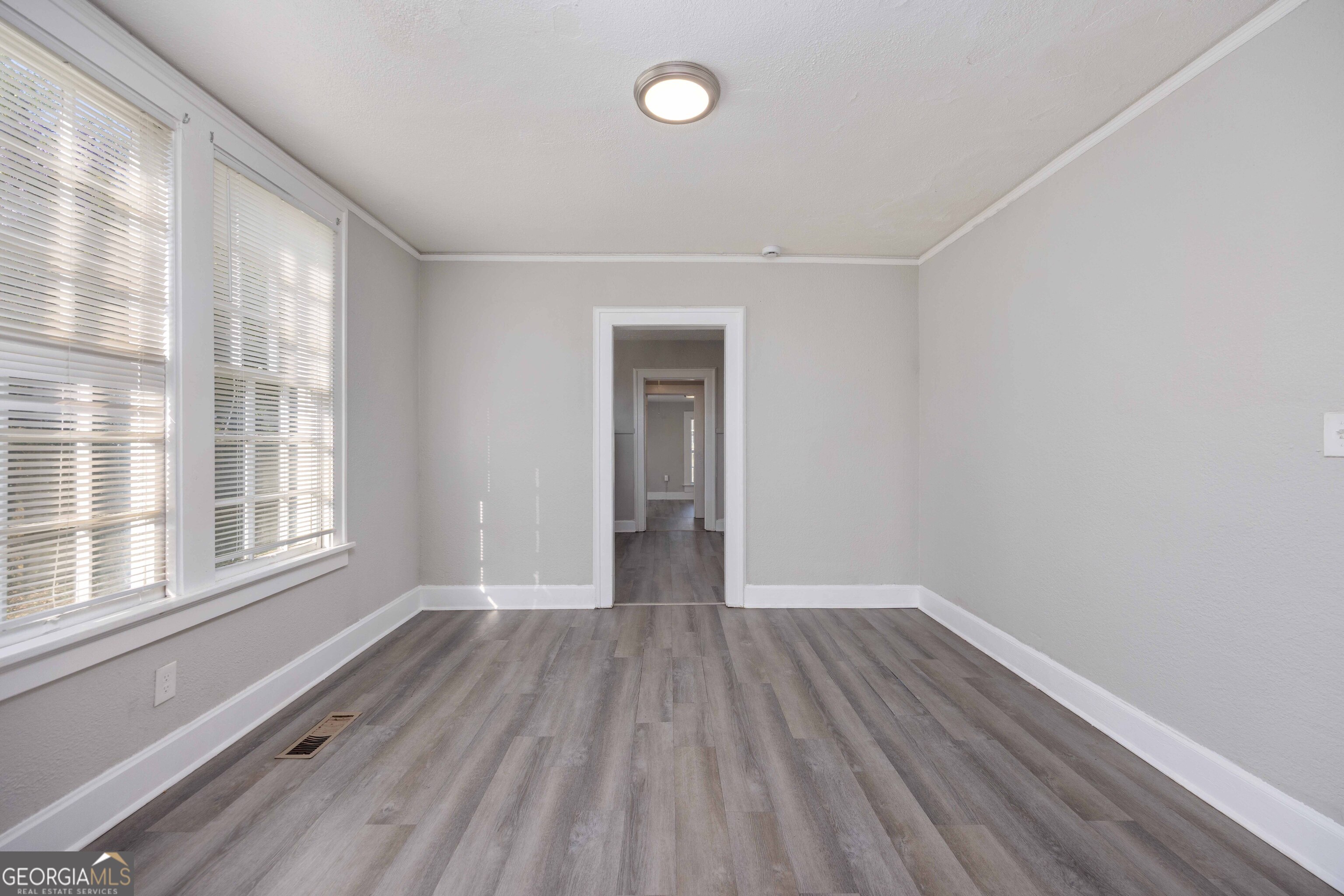 1103 Bryan Avenue Columbus, GA 31906 - Photo 8 of 24 a view of an empty room with wooden floor and a window