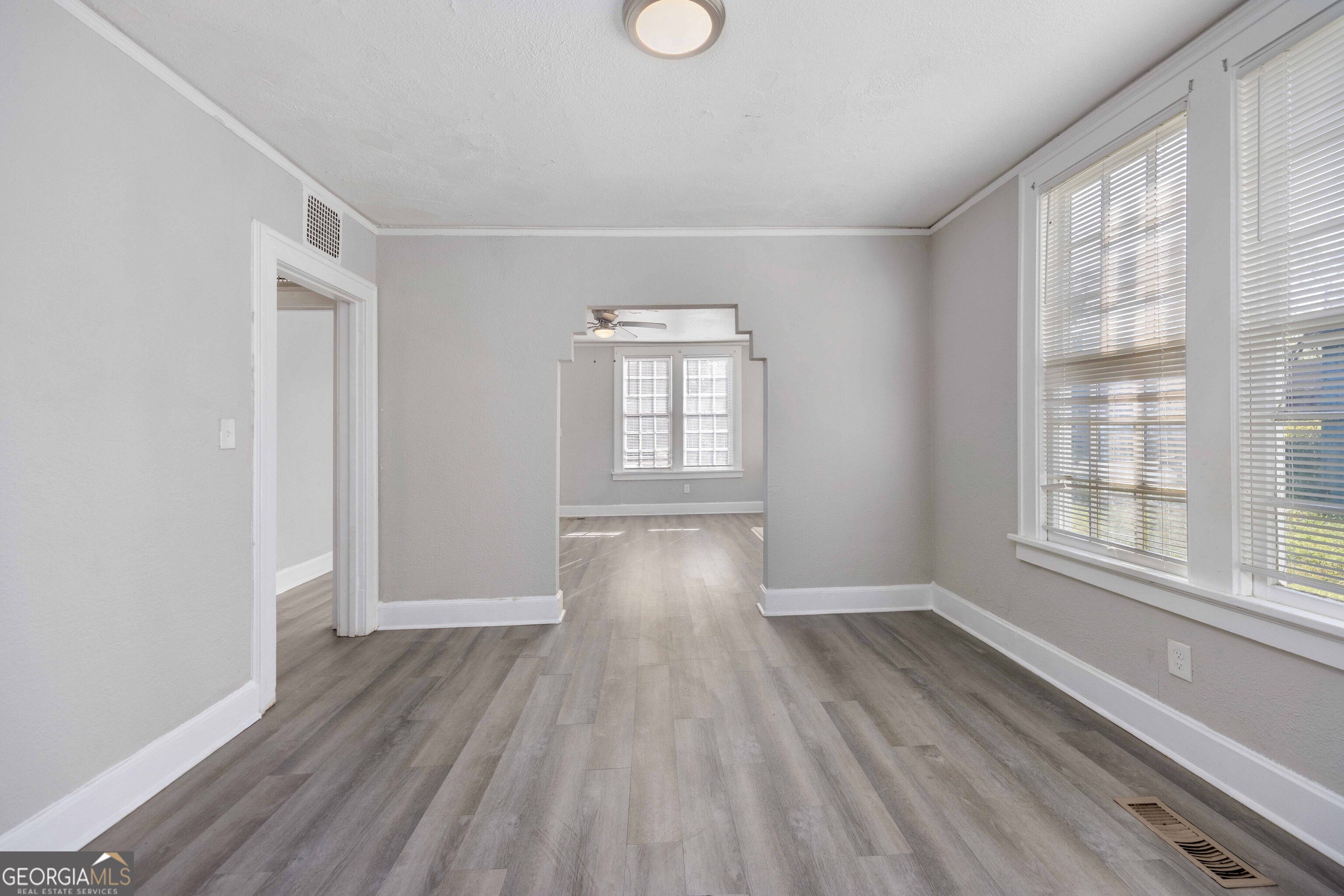 1103 Bryan Avenue Columbus, GA 31906 - Photo 9 of 24 an empty room with wooden floor and windows