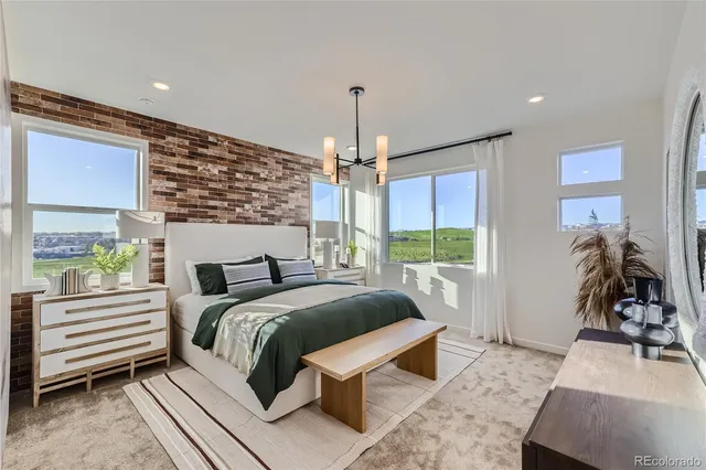 a bedroom with a bed and a large window