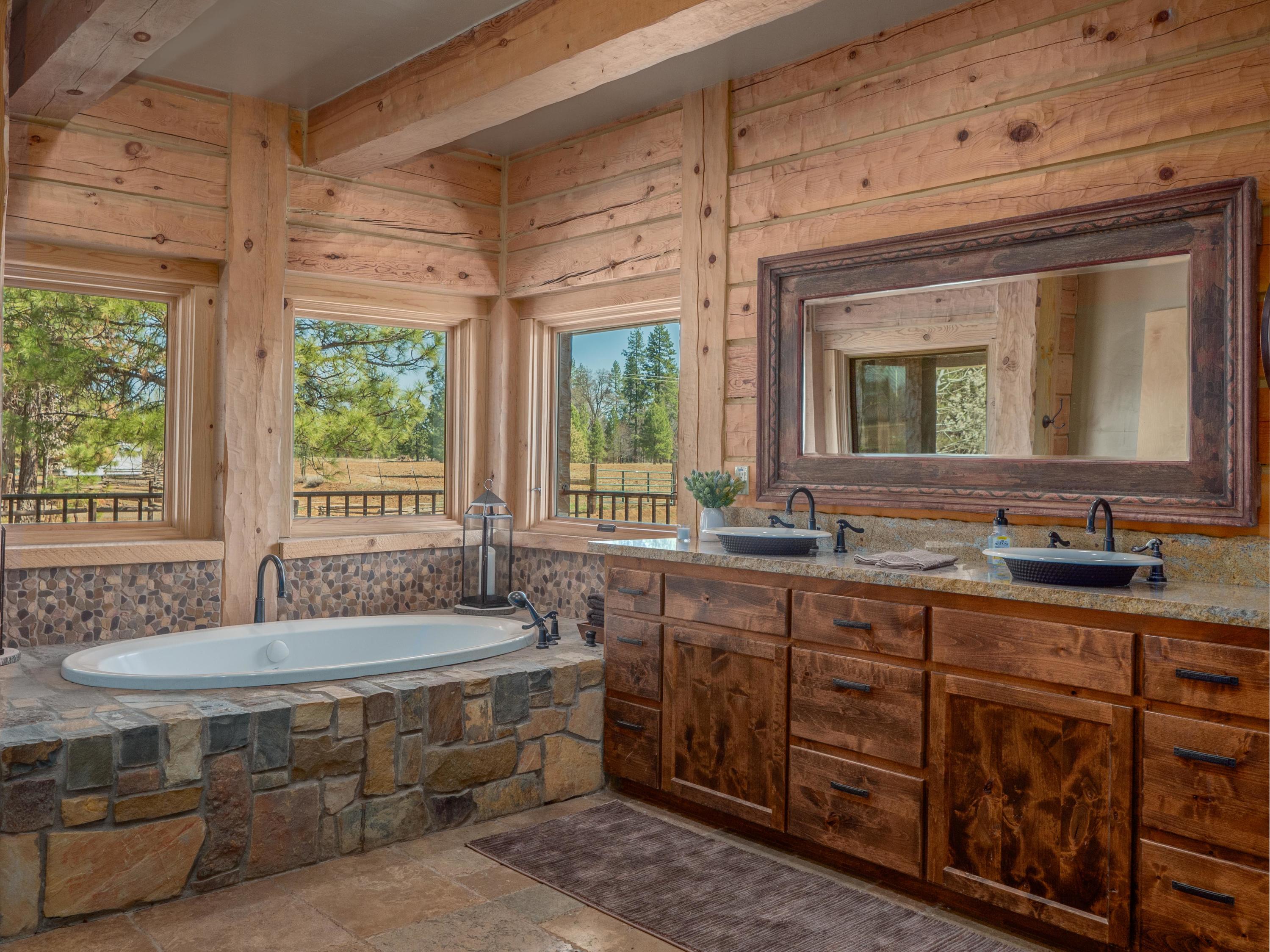 40900 Brown Road Fall River Mills, CA 96028 - Photo 23 of 72 a spacious bathroom with a double vanity sink large mirror and a bathtub
