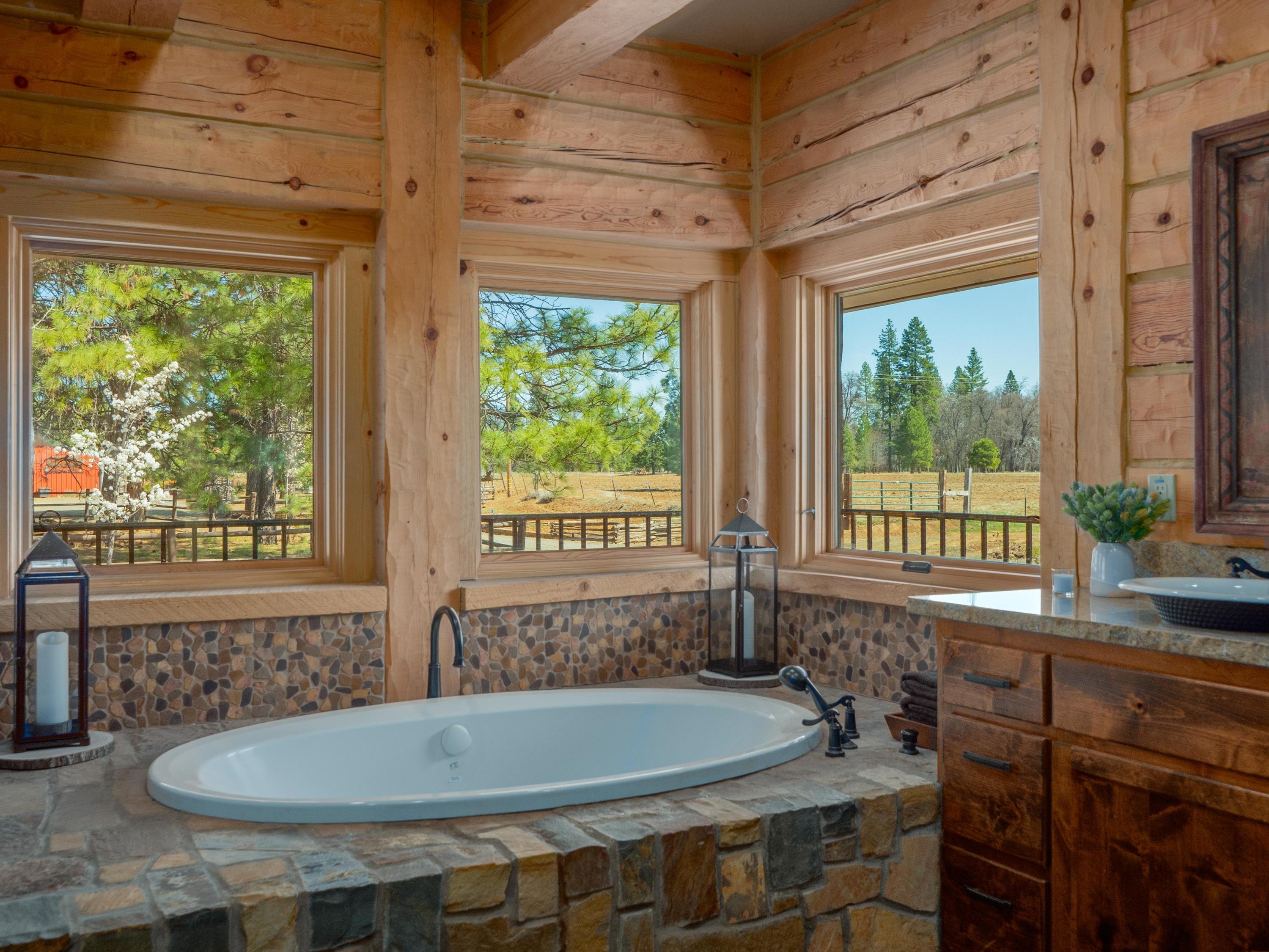 40900 Brown Road Fall River Mills, CA 96028 - Photo 24 of 72 a bath tub sitting in a bathroom next to a window