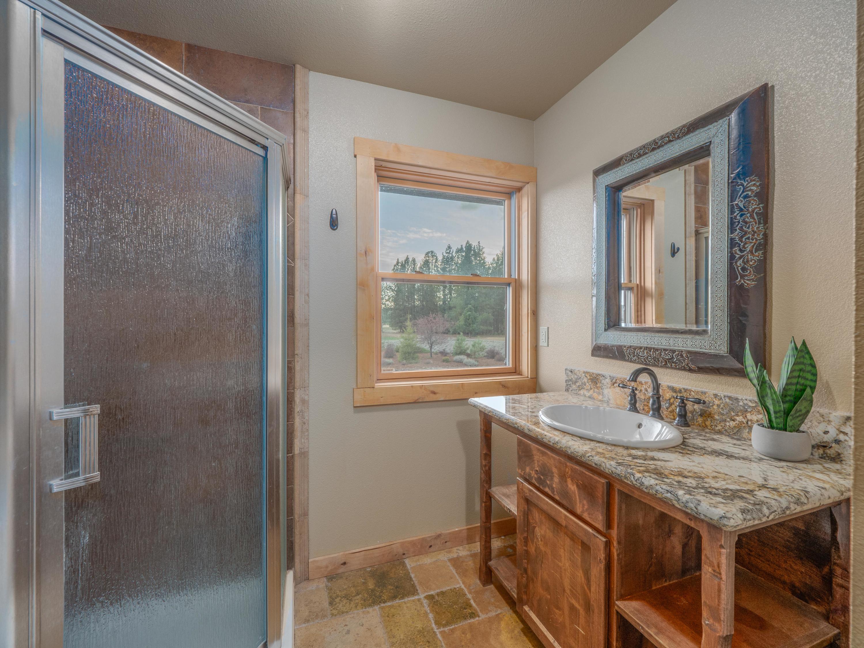 40900 Brown Road Fall River Mills, CA 96028 - Photo 53 of 72 a bathroom with a granite countertop sink and a window