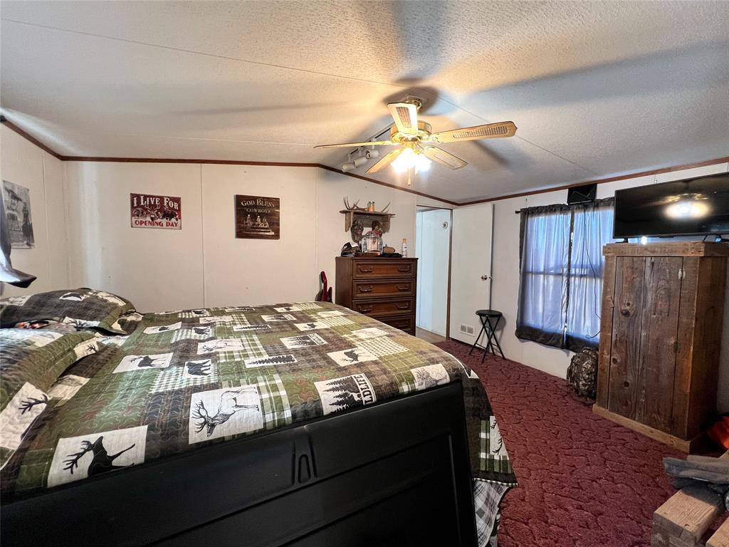 148 Rule Tx 79547 Rule, TX 79547 - Photo 15 of 39 a bedroom with a bed and a chandelier