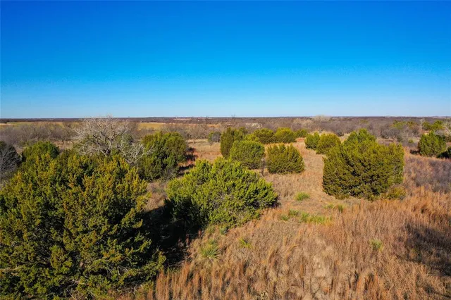 an aerial view of house with yard and mountain view in back
