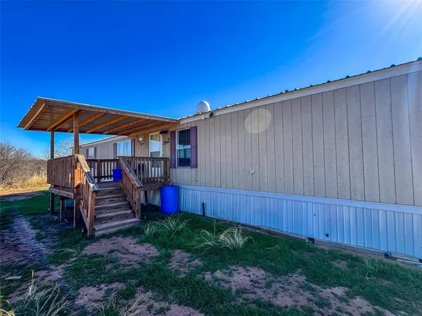 a view of a backyard with sitting area