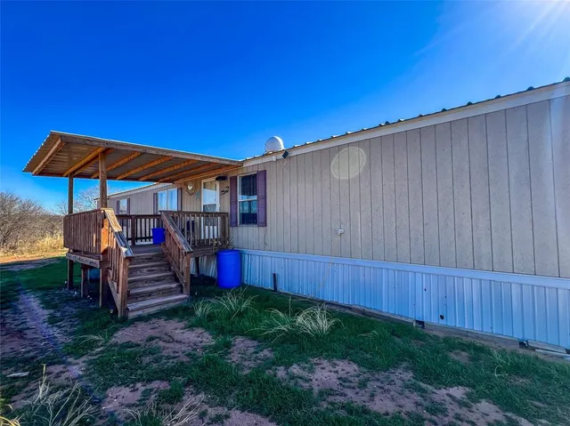 a view of a backyard with sitting area