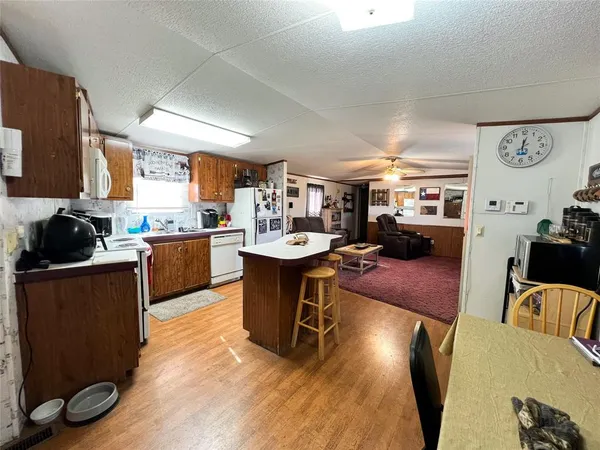 a living room with lots of furniture and kitchen view