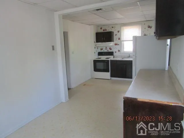 a kitchen with stainless steel appliances a refrigerator and a stove top oven