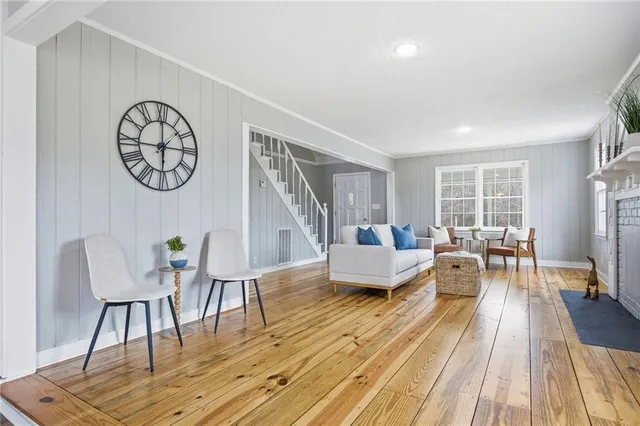 a view of a a dining room with furniture window and wooden floor