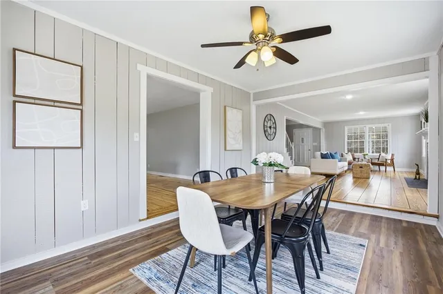 a dining room with furniture a chandelier and wooden floor