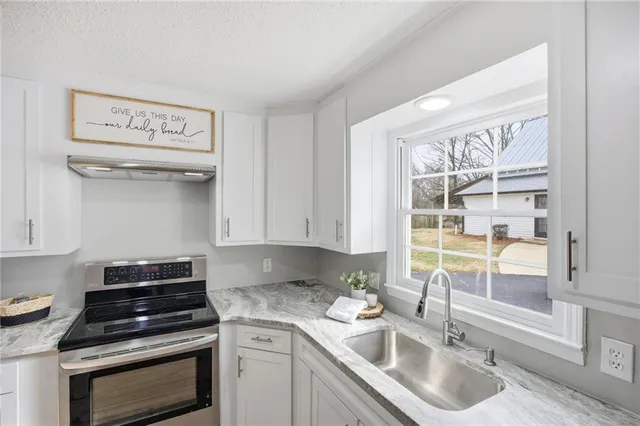 a living room with a bed furniture and a window