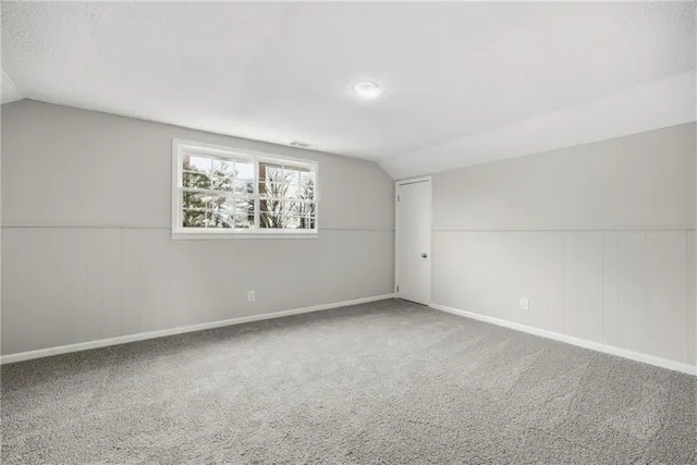 a view of a house with backyard and a parking space