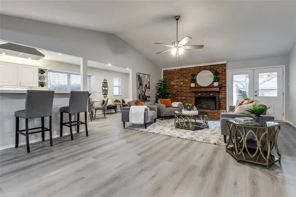 a living room with furniture a wooden floor and a fireplace