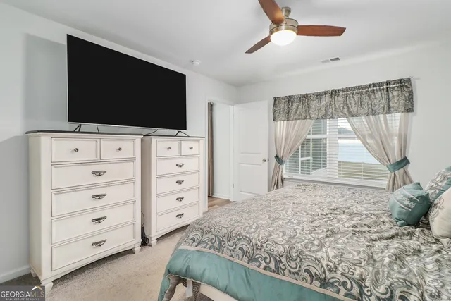 a view of bedroom with a flat tv screen and dresser
