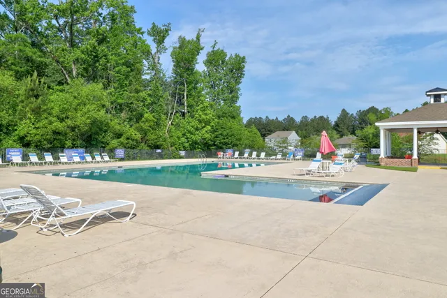 a view of swimming pool and trees in the background