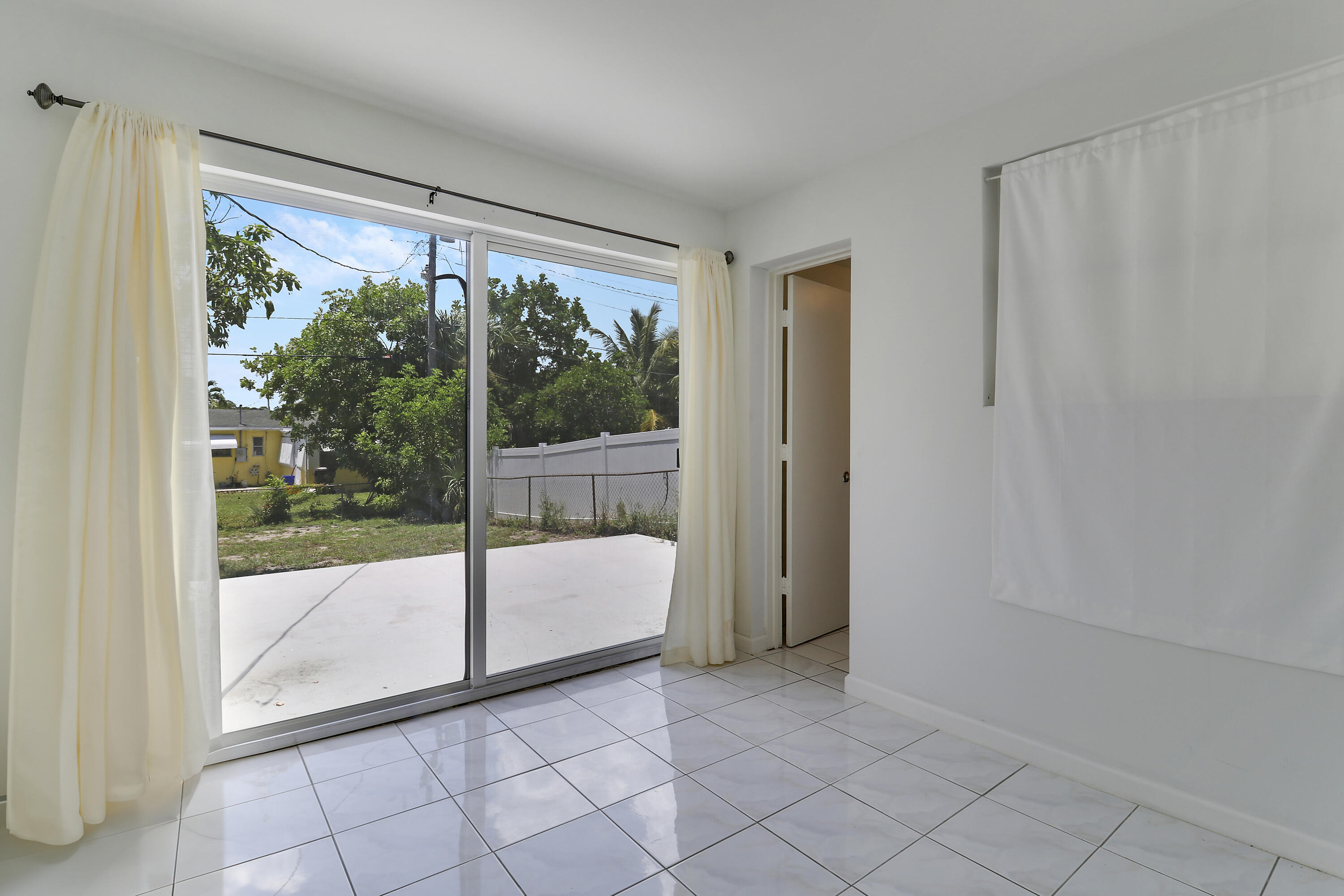 5519 Columbus Road West Palm Beach, FL 33405 - Photo 12 of 22 a view of a room with sliding glass door and porch