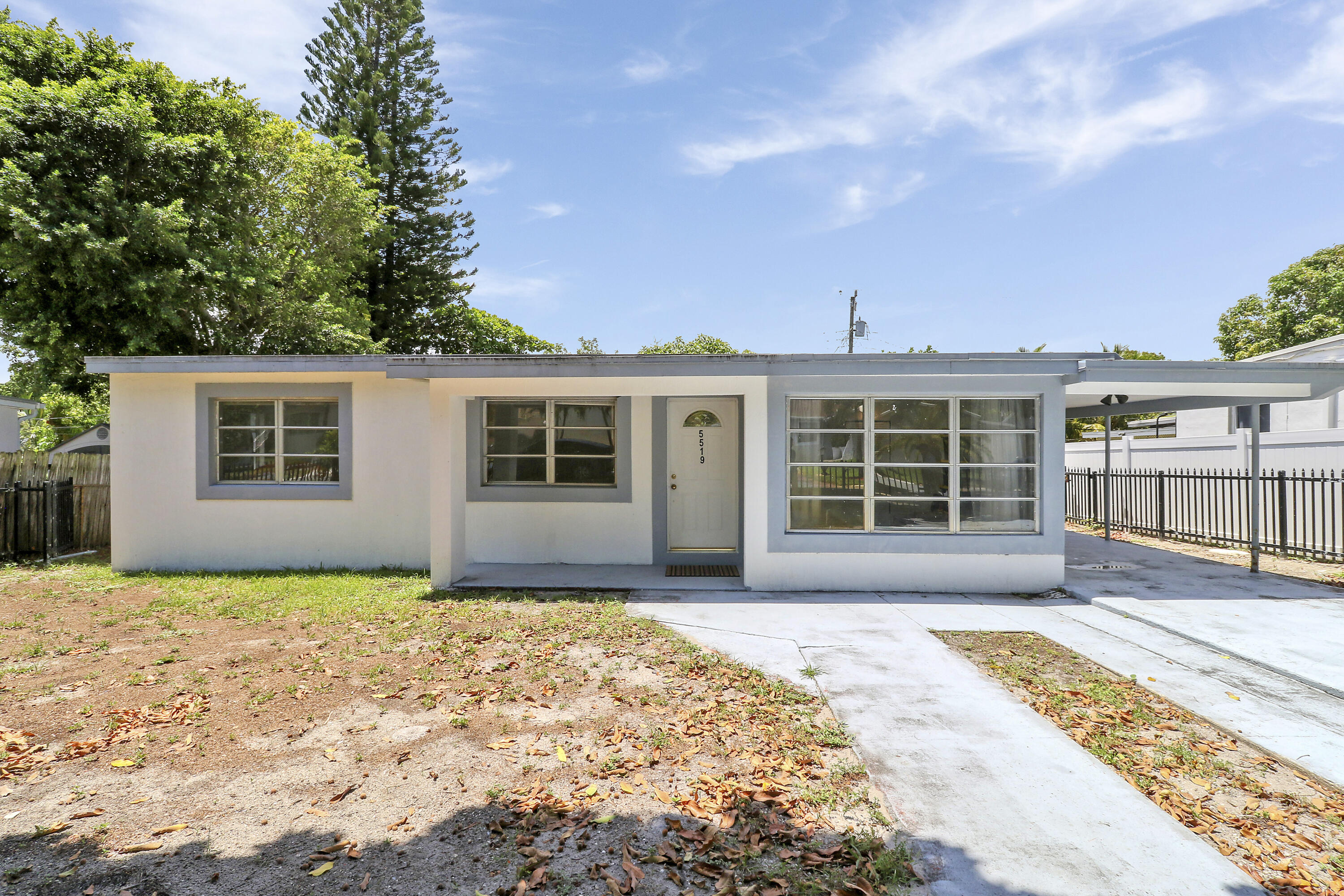 5519 Columbus Road West Palm Beach, FL 33405 - Photo 16 of 22 front view of a house with a patio