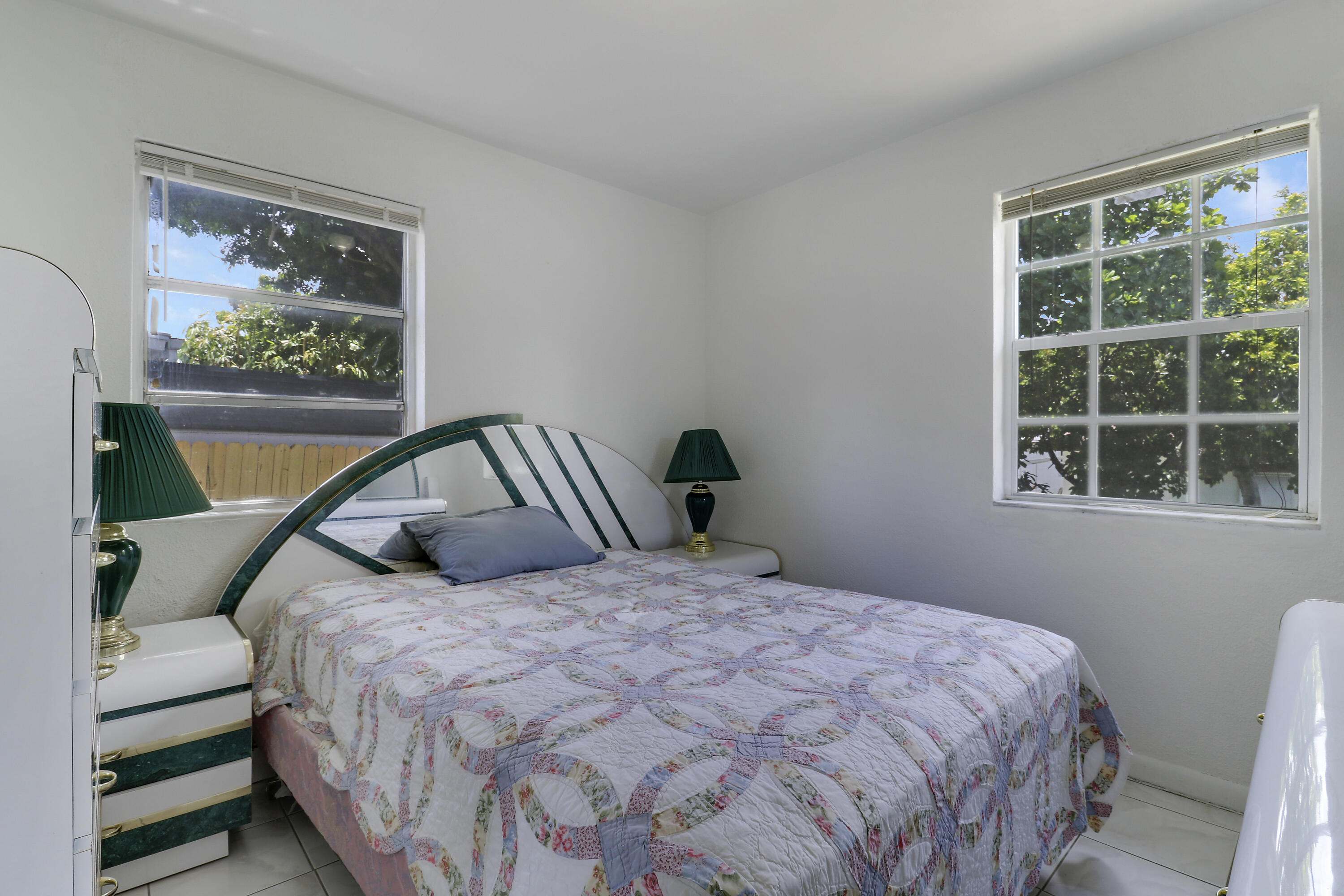 5519 Columbus Road West Palm Beach, FL 33405 - Photo 8 of 22 a bedroom with a bed and a window