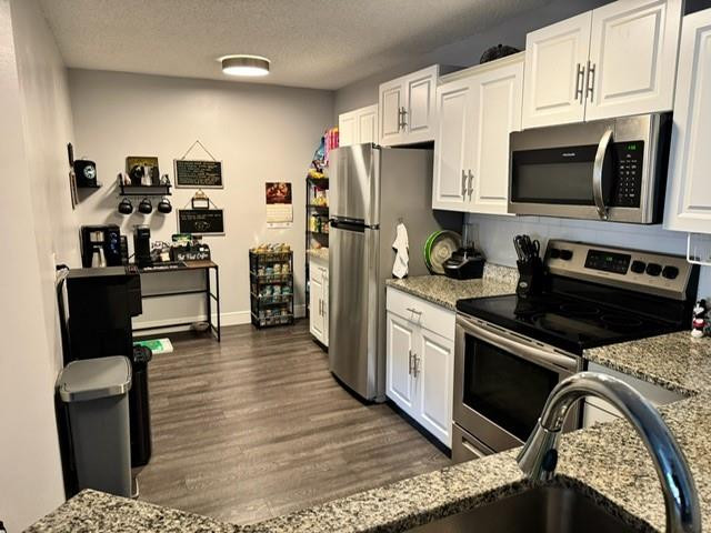 8871 Wiles Road, Unit 201 Coral Springs, FL 33067 - Photo 1 of 70 a kitchen with stainless steel appliances granite countertop a refrigerator stove and white cabinets