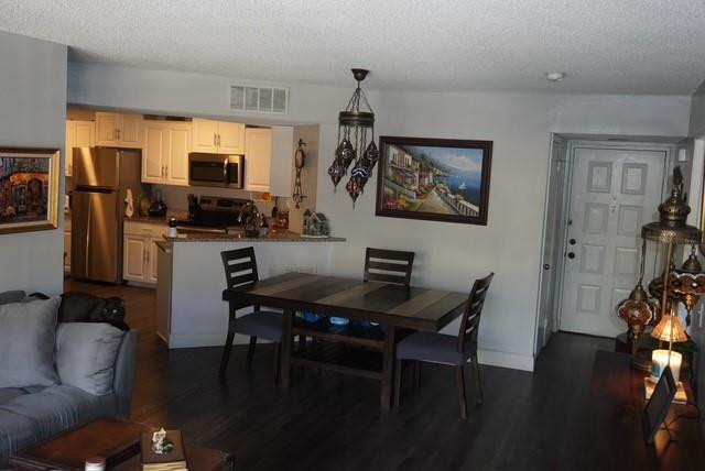 8871 Wiles Road, Unit 201 Coral Springs, FL 33067 - Photo 23 of 70 a view of a workspace with furniture and wooden floor