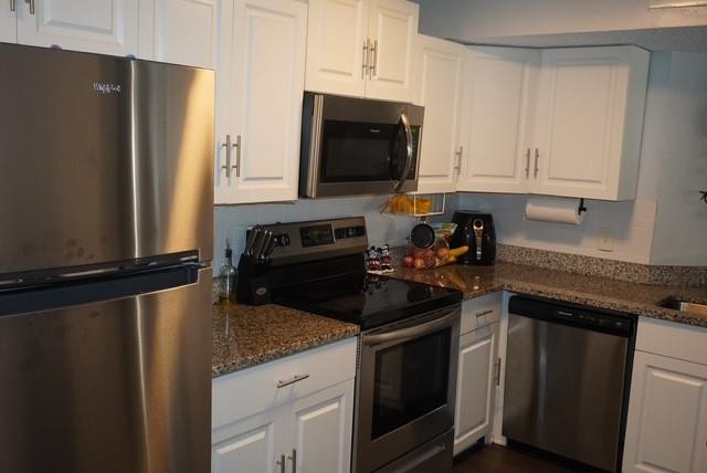 8871 Wiles Road, Unit 201 Coral Springs, FL 33067 - Photo 26 of 70 a kitchen with a sink and a refrigerator