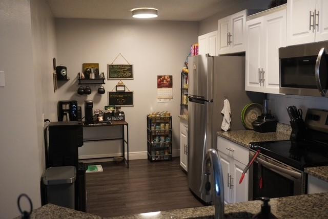 8871 Wiles Road, Unit 201 Coral Springs, FL 33067 - Photo 27 of 70 a kitchen with stainless steel appliances a refrigerator stove and microwave