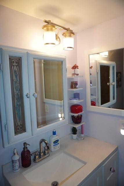 8871 Wiles Road, Unit 201 Coral Springs, FL 33067 - Photo 34 of 70 a bathroom with a sink vanity mirror and toilet