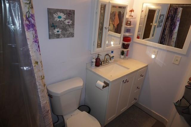 8871 Wiles Road, Unit 201 Coral Springs, FL 33067 - Photo 36 of 70 a bathroom with a toilet sink and mirror