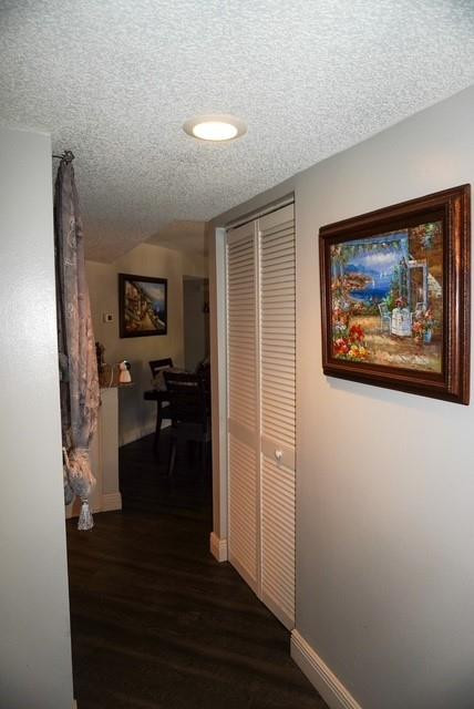 8871 Wiles Road, Unit 201 Coral Springs, FL 33067 - Photo 39 of 70 a view of a hallway with wooden floor and a workspace