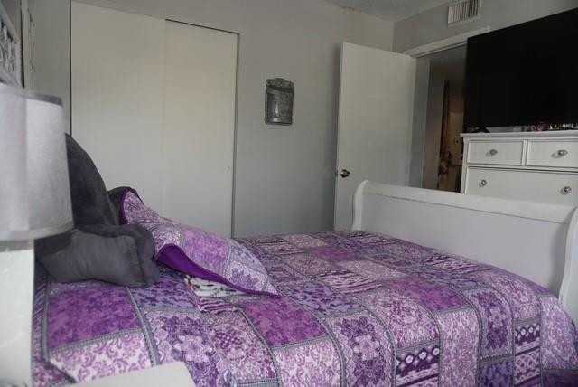 8871 Wiles Road, Unit 201 Coral Springs, FL 33067 - Photo 44 of 70 a bedroom with a bed and a flat screen tv