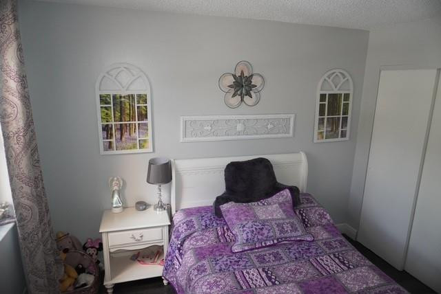 8871 Wiles Road, Unit 201 Coral Springs, FL 33067 - Photo 45 of 70 a bedroom with a bed and wooden floor