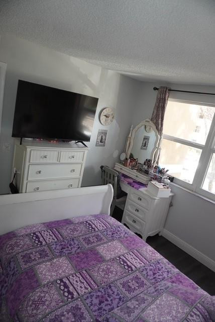 8871 Wiles Road, Unit 201 Coral Springs, FL 33067 - Photo 46 of 70 a bedroom with a bed and flat screen tv