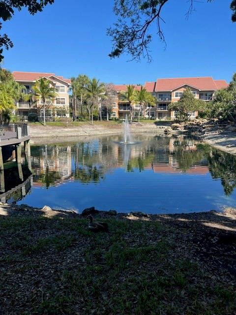 8871 Wiles Road, Unit 201 Coral Springs, FL 33067 - Photo 5 of 70 a view of a lake with houses in the background