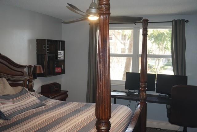 8871 Wiles Road, Unit 201 Coral Springs, FL 33067 - Photo 53 of 70 a bedroom with a bed and wooden floor