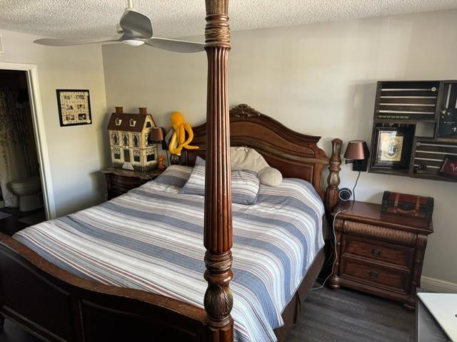 8871 Wiles Road, Unit 201 Coral Springs, FL 33067 - Photo 54 of 70 a bedroom with a bed and wooden floor