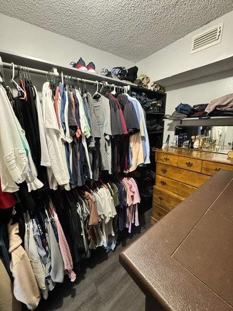 8871 Wiles Road, Unit 201 Coral Springs, FL 33067 - Photo 66 of 70 a view of walk in closet with clothes and shoes