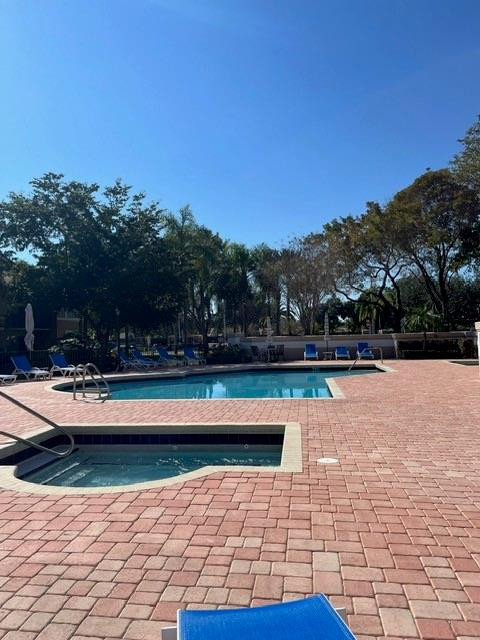 8871 Wiles Road, Unit 201 Coral Springs, FL 33067 - Photo 7 of 70 a view of swimming pool with lounge chair in front of house