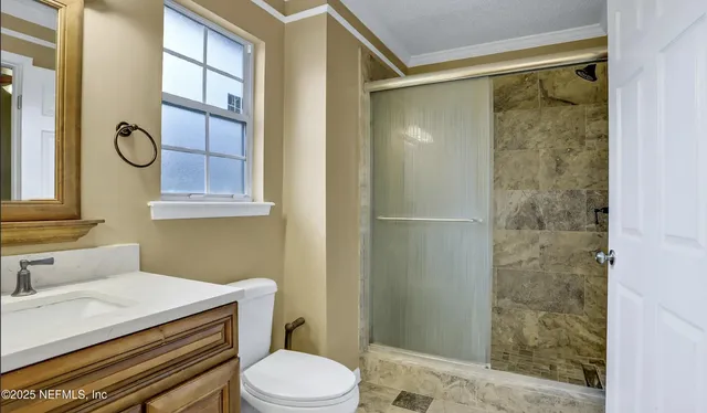 a bathroom with a sink toilet and shower