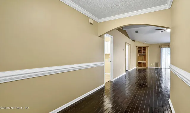 a view of a room with wooden floor and brick walls