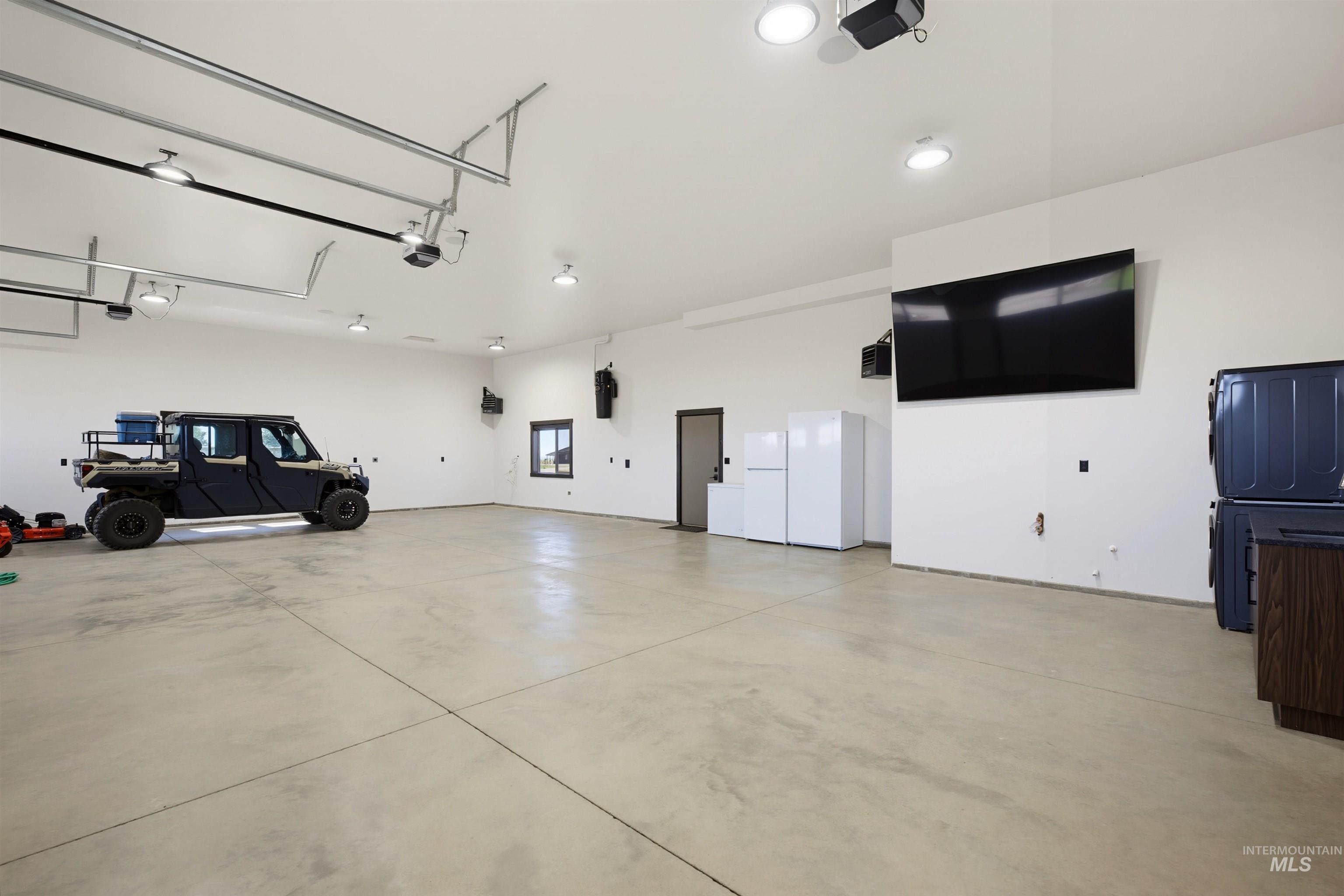 13945 Galloping Road McCall, ID 83638 - Photo 42 of 50 Spacious garage with concrete flooring and high ceilings