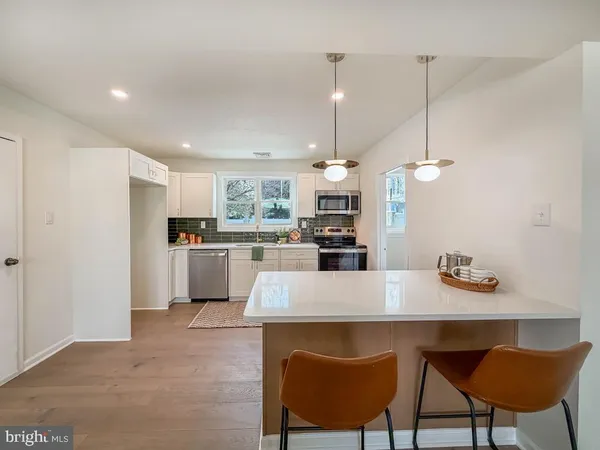 a large kitchen with a table and chairs