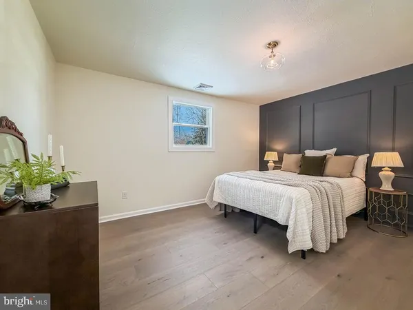 a bedroom with a bed and potted plant